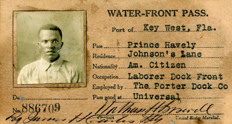 a card with a man's photograph and information that was used to provide access to the Key West waterfront during World War One.