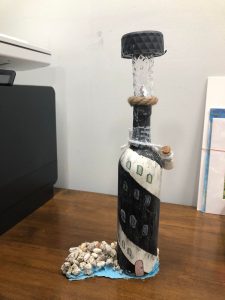A bottle painted to look like a lighthouse