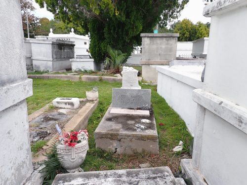 A grave surrounded by crupts and other gravesites.