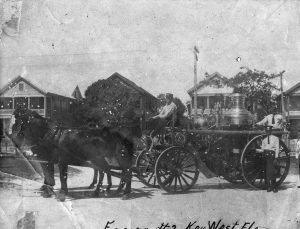 Three men with a carriage attached to two horses.