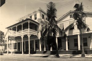 A three story building with a sign that reads Overseas Hotel.