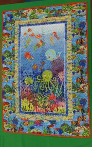 a quilt with sea creatures and coral