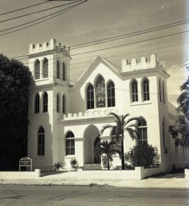 A white church with square towers on either side of the entrance.