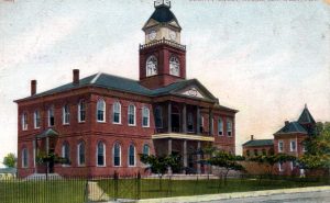 A two story brick building with a clock tower.