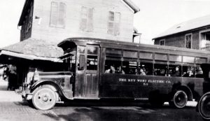 A bus with lettering that reads the key west electric co. 53