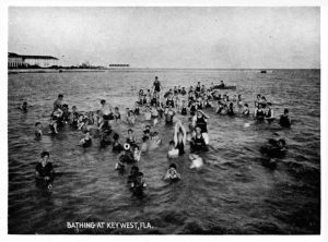 A group of people in the water. Writing on photo reads Bathing at Key West, Fla.