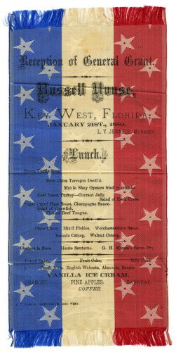 A red white and blue menu with printing on it reading Reception of General Grant. Russell House. Key West Florida. January 21st, 1880. L.Y. Jenness, manager. Lunch with menu listings.